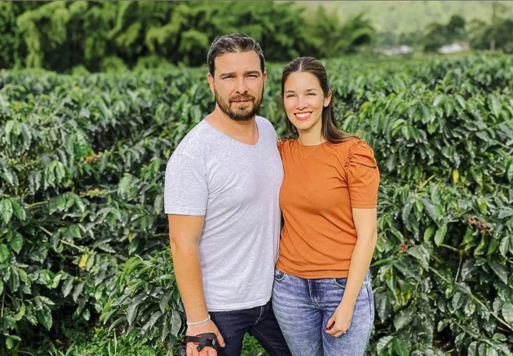 owners of progeny coffee in a field