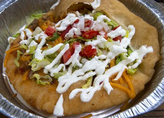 Three Sisters Frybread’s Cherokee Taco with chicken, lettuce, tomatoes, cojita cheese and sour cream.