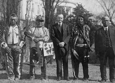 a group of men from different native american backgrounds standing together, black and white