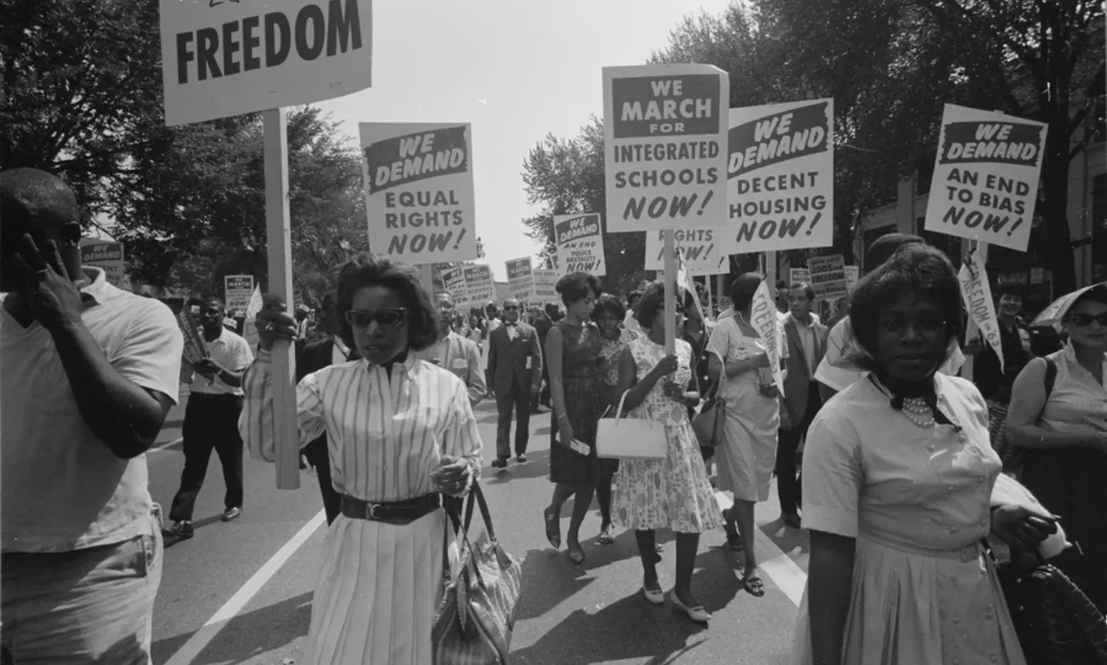 At the March on Washington on Aug. 28, 1963, African Americans carry placards demanding equal rights, integrated schools, decent housing and an end to bias.