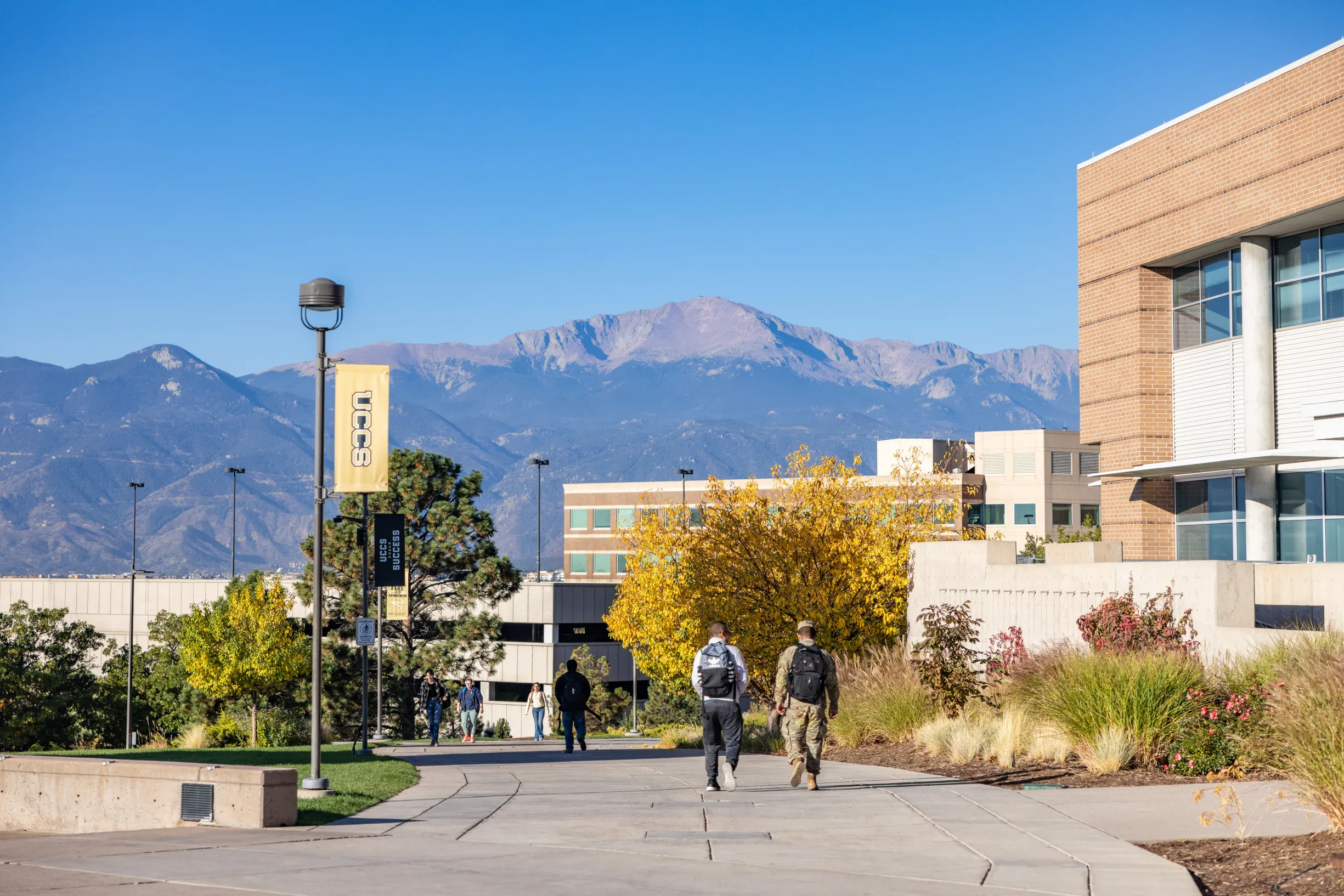 Two students walking down the UCCS Spine